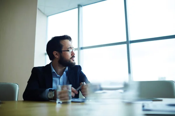 Employer in formalwear sitting by workplace — Stock Photo, Image