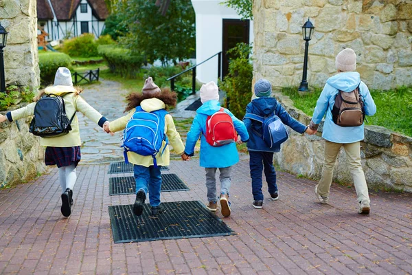 Happy schoolkids running — Stock Photo, Image