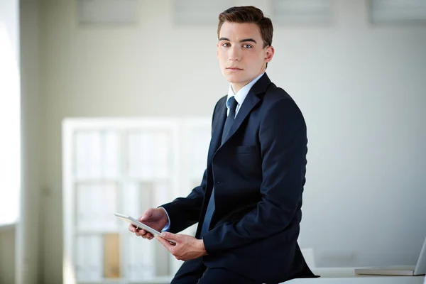 Serious leader with touchpad — Stock Photo, Image