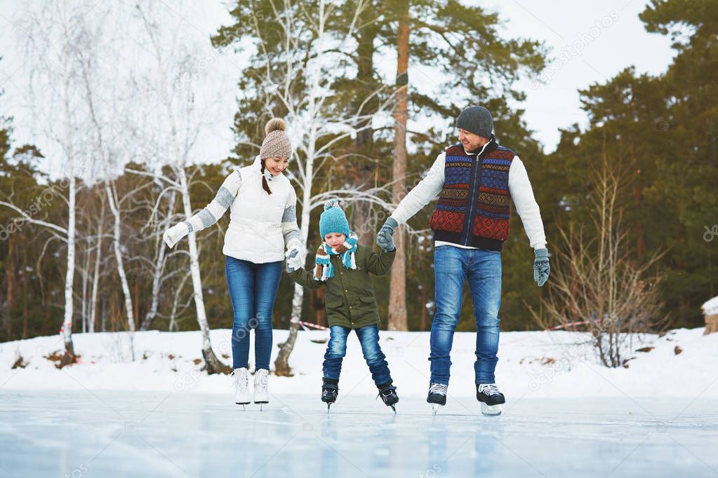 Cheerful family skating in park