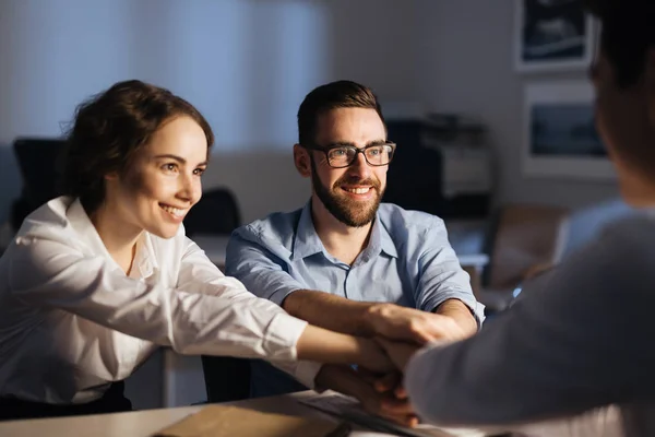 Co-workers keeping their hands on top of each other — Stock Photo, Image
