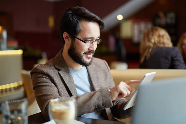 Üzletember, digitális tabletta asztalnál ült — Stock Fotó