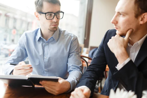 Businessmen sitting in cafe — Stock Photo, Image