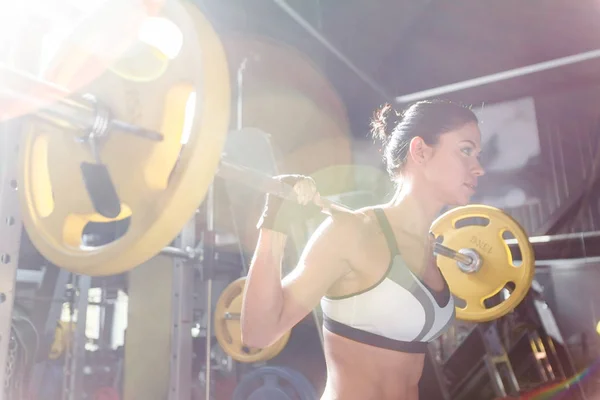 Kvinna lyftande vikt i gymmet — Stockfoto