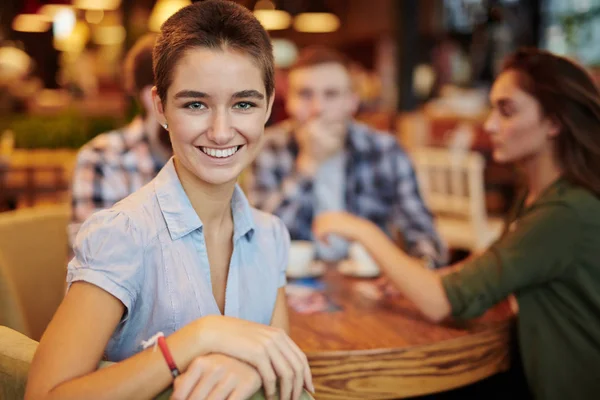 Girl sitting in cafe — Stock Photo, Image
