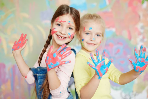 Girls with hands in color paint — Stock Photo, Image