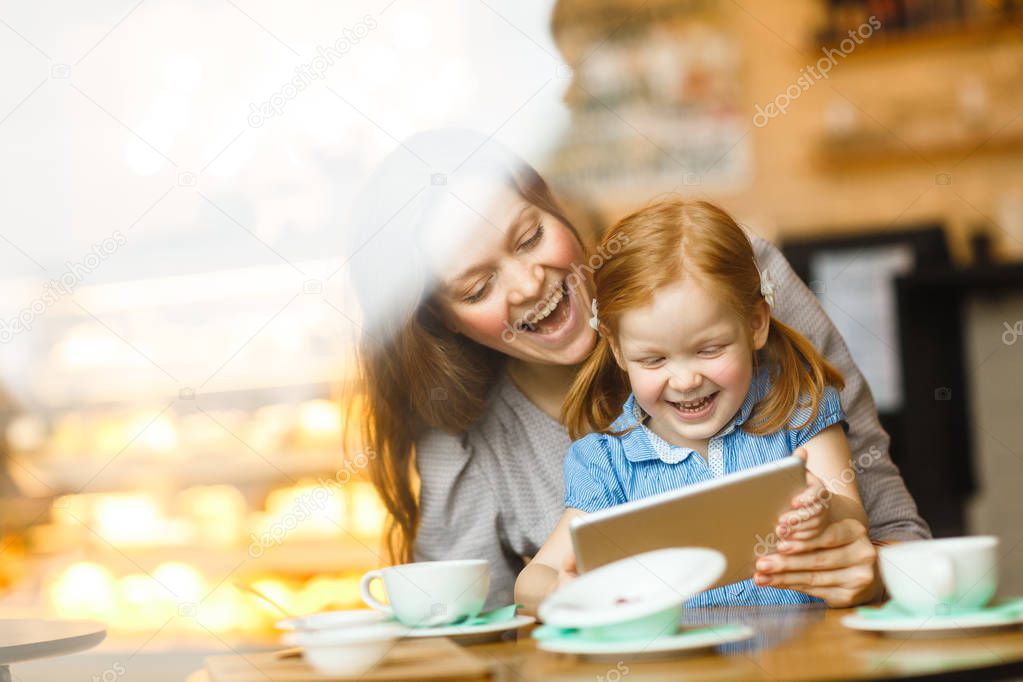 Mother and child using digital tablet