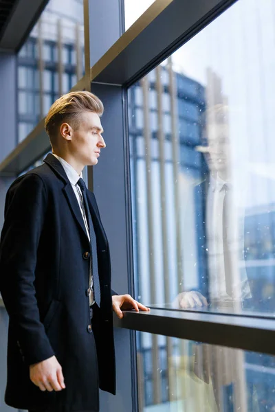 Businessman by window — Stock Photo, Image