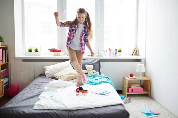 Girl dancing on bed — Stock Photo, Image