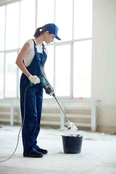 Worker mixing whitewash in bucket — Stock Photo, Image