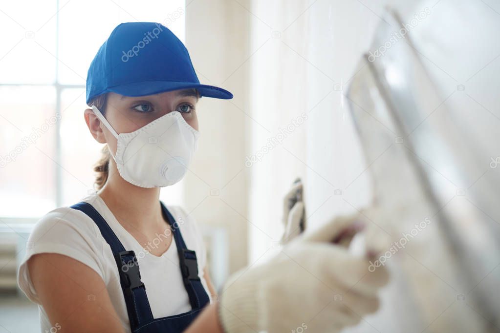 female repairperson carrying out plasterwork
