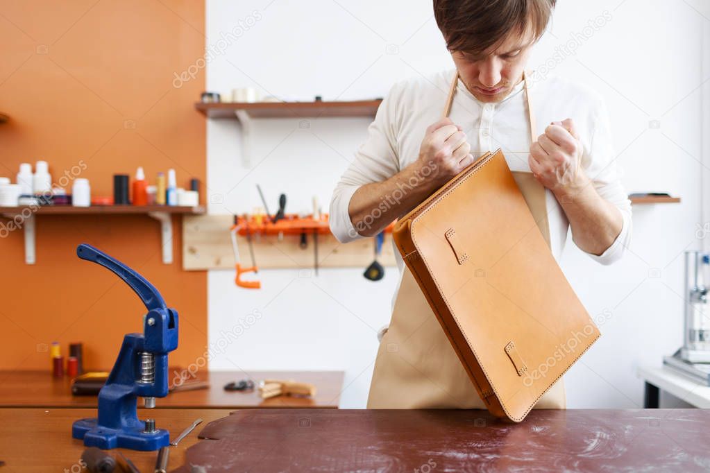 man making leather briefcase