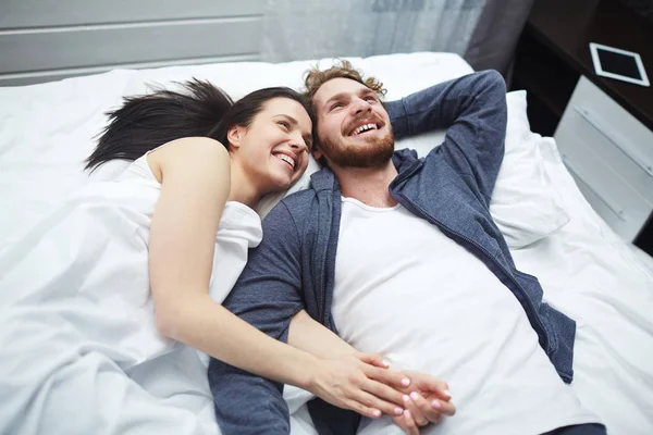 Pareja relajándose en la cama — Foto de Stock