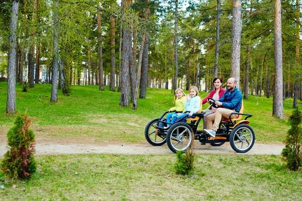 Family riding quadricycle car — Stock Photo, Image