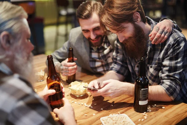 Three bearded men with bottles — Stock Photo, Image