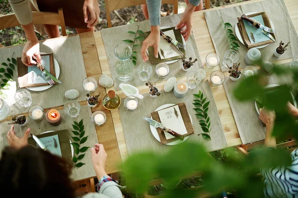 Amigos sirviendo mesa para la cena — Foto de Stock