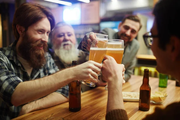 Men holding glasses — Stock Photo, Image