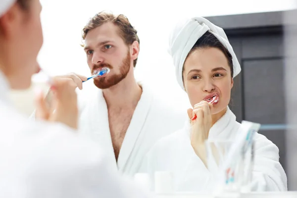 Young couple in white bathrobes — Stock Photo, Image