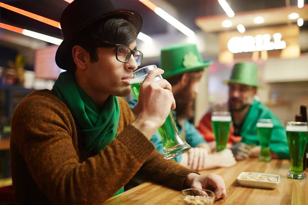 Calm guy in hat drinking — Stock Photo, Image