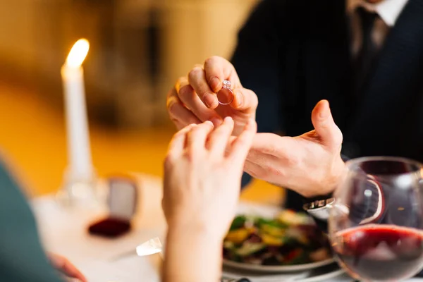 Man putting engagement ring — Stock Photo, Image