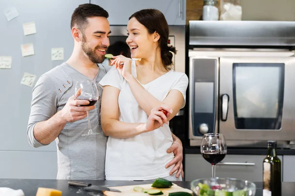 Woman giving slice of fresh cucmber — Stock Photo, Image