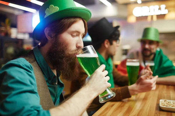 Young bearded man drinking — Stock Photo, Image