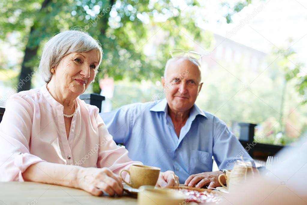 Pretty senior couple in outdoor cafe