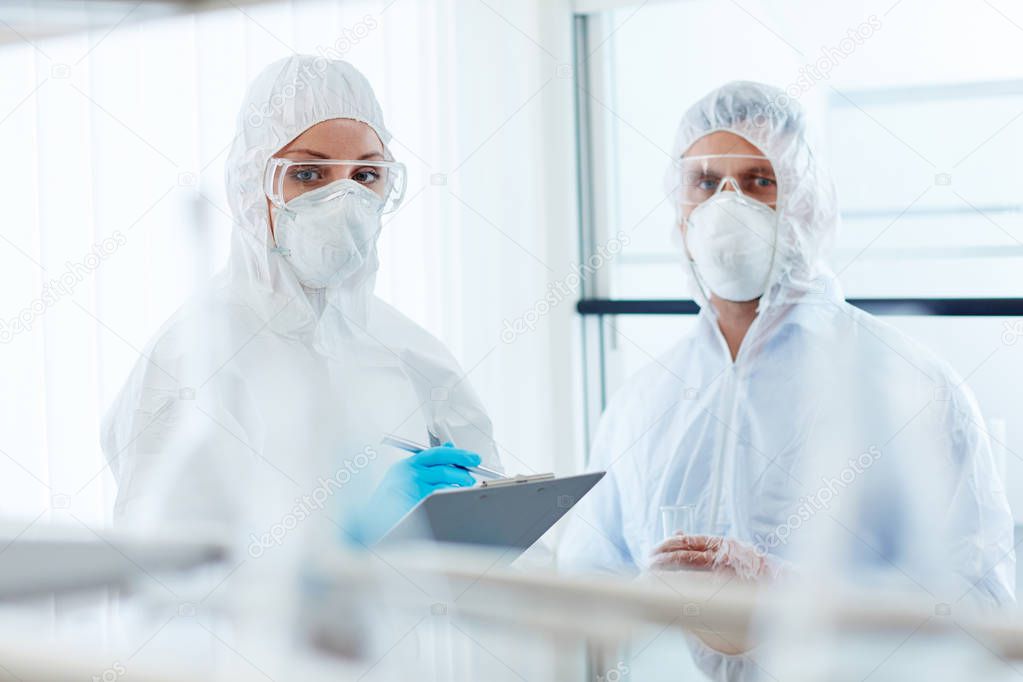 colleagues in eyeglasses, gloves and respirators