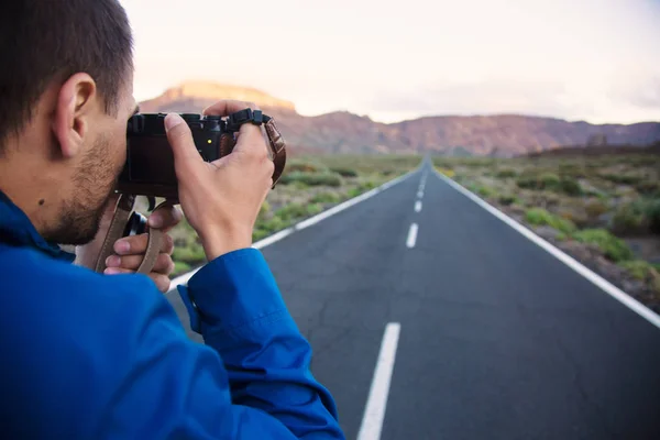 Hombre tomando fotos del paisaje de la carretera — Foto de Stock