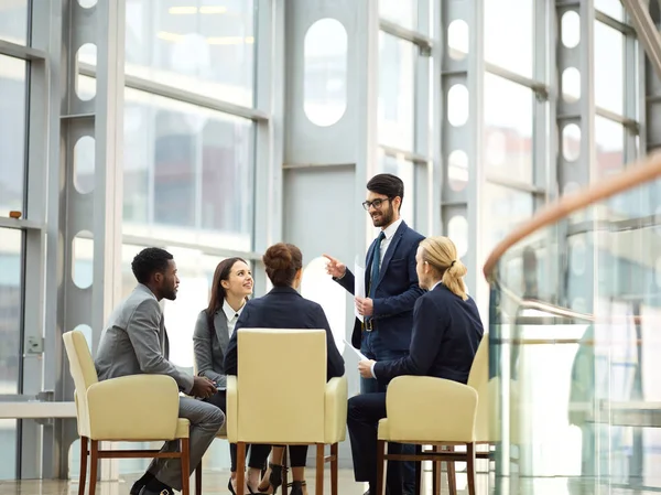 Successful business people listening to speaker — Stock Photo, Image