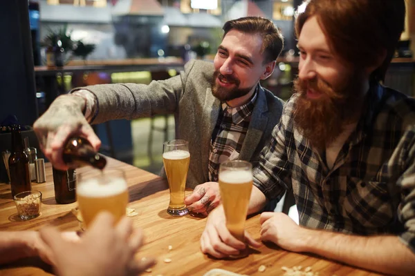 Homem derramando cerveja em vidro — Fotografia de Stock