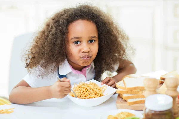 Curly little girl with full mouth — Stock Photo, Image