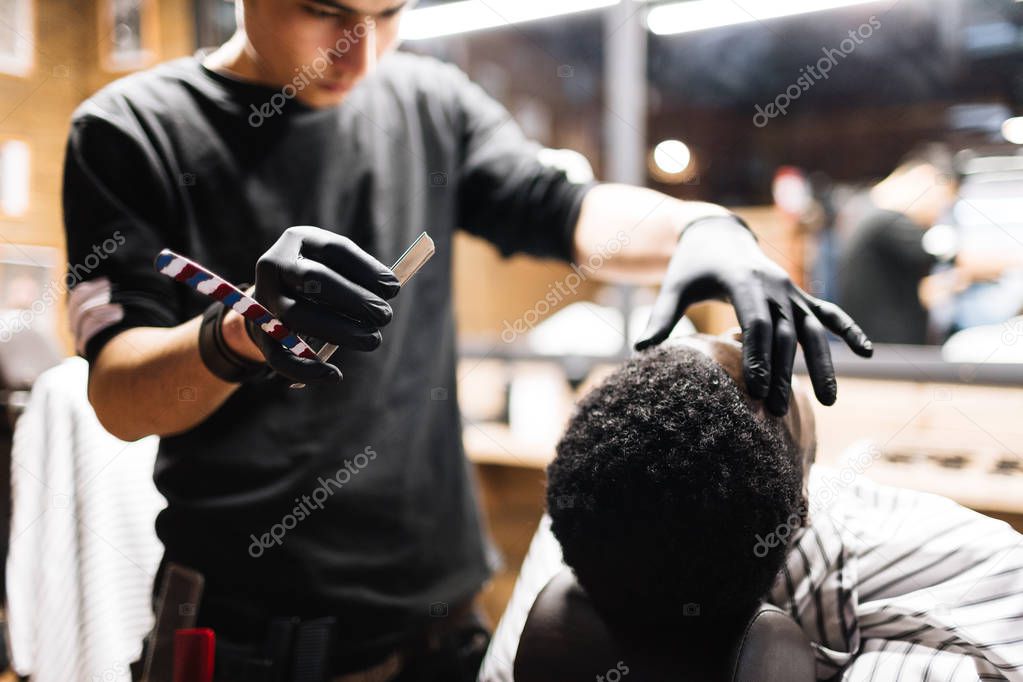 Barber touching head of client 