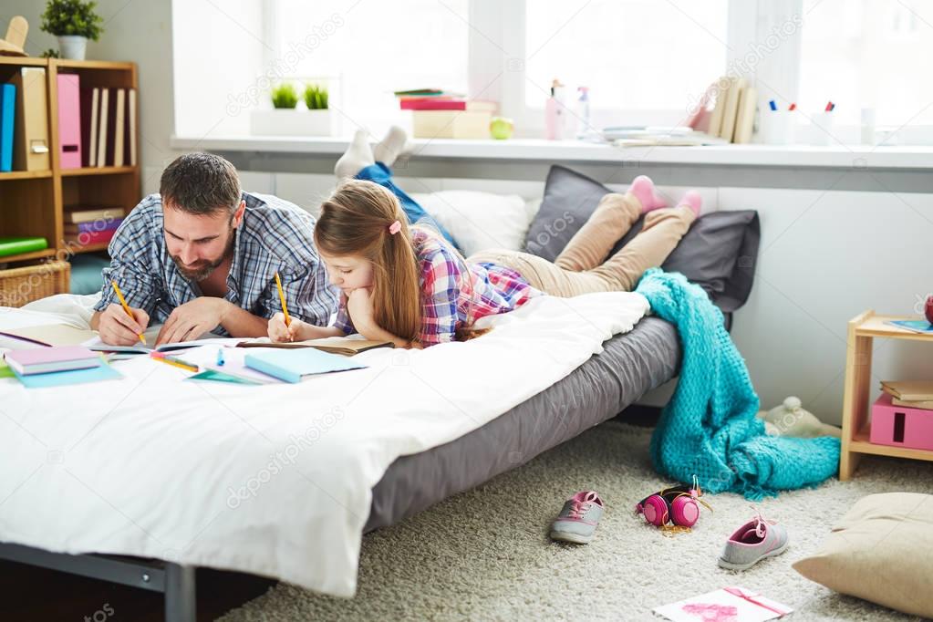 man and daughter drawing pictures