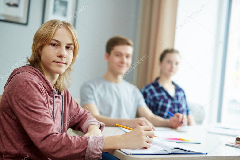 student sitting by desk