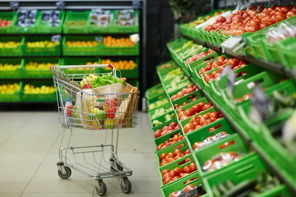 Metal shopping trolley with grocery — Stock Photo, Image