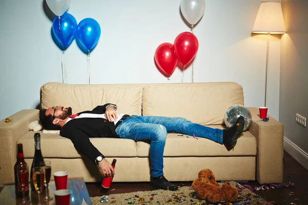 Man lying on couch — Stock Photo, Image