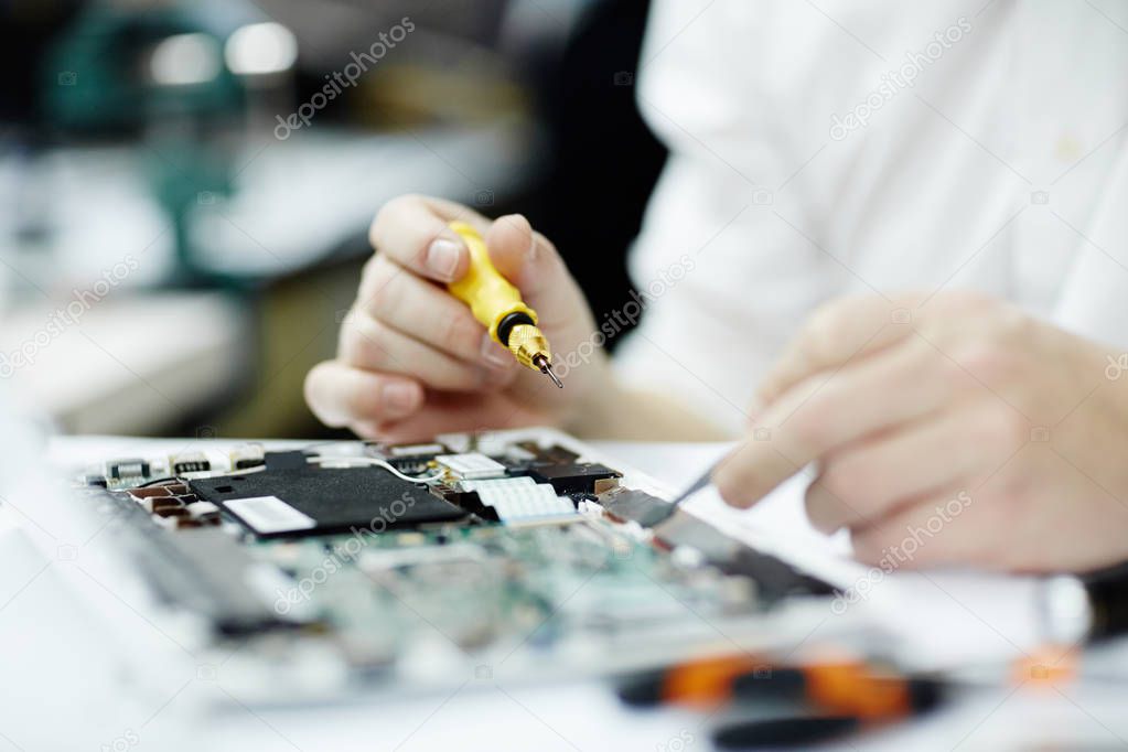 man assembling circuit board 