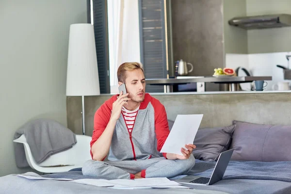 Modern Employee Reading Papers Speaking Smartphone Home — Stock Photo, Image