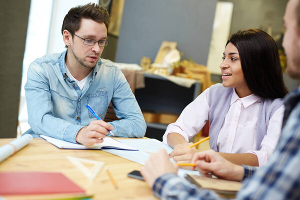 Contemporary students of design faculty discussing new topic