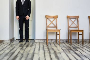 Şık Ajan kapalı kapının yanında takım ayakta