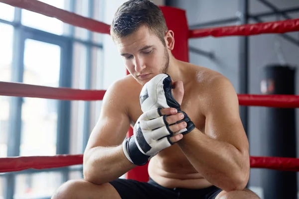 Portrait Sweaty Shirtless Man Sitting Boxing Ring Adjusting Gloves Fight — Stock Photo, Image
