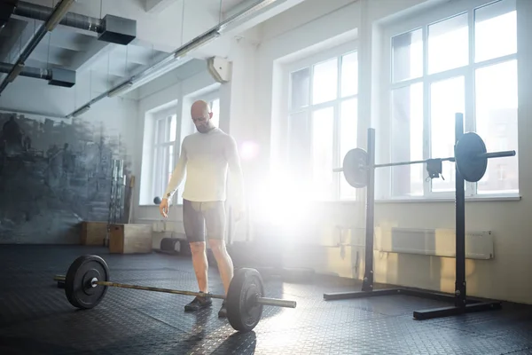 Portrait Strongman Ready Lift Heavy Barbell Floor Workout Sunlit Gym — Stock Photo, Image