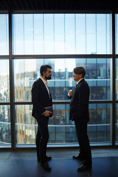 Profile View Two Serious Business Partners Standing Panoramic Window While — Stock Photo, Image