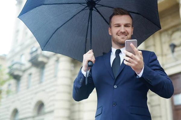 Mutlu Genç Ajan Ile Smartphone Içinde Şemsiye Manifatura — Stok fotoğraf