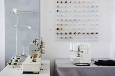 Arka plan resmi boş terzilik stüdyo ve dikiş makinesi ve Singer üstünde o ile tablolar
