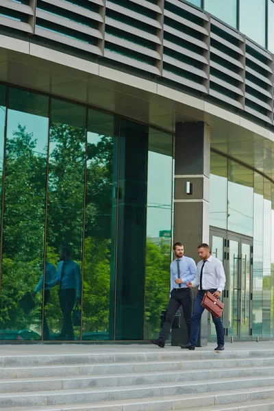 Two Young Businessmen Walking Steps Modern Office Building Glass Fronts — Stock Photo, Image