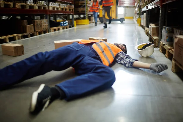 Fallen Worker Lying Floor Aisle Storage Shelves — Stock Photo, Image