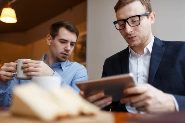 Des Collègues Sérieux Regardent Écran Tactile Dans Café — Photo