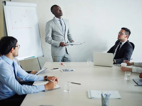 stock image Portrait of successful African-American business man standing at white board giving presentation of marketing research during company meeting in conference room of modern office